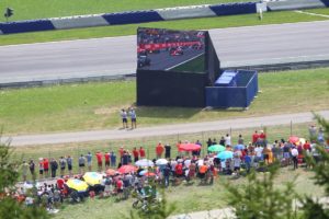 Standing area at the Red Bull Ring with guests in front of a screen
