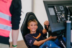 Race simulator with child showing great joy