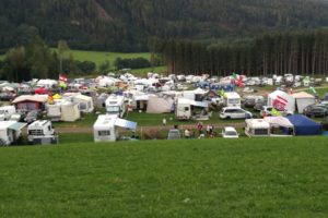 View of the campsite with green meadow